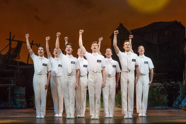 Joel Granger and Mormon Ensemble in THE BOOK OF MORMON. Image Jeff Busby